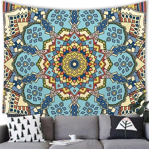 Detail of bohemian mandala tapestry featuring blue geometric patterns on a living room wall