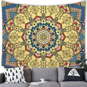 Detail view of a large geometric mandala tapestry hanging over a modern sofa in a living room