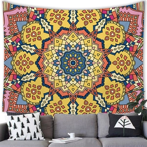Vibrant mandala wall tapestry hanging above a grey sofa in a modern home interior
