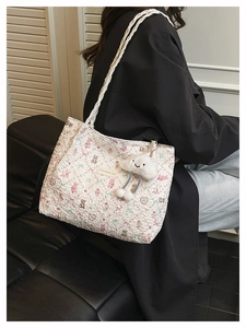 Detailed view of the bubble texture tote bag featuring cute bears and a cloud pendant
