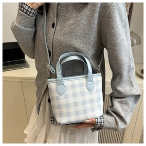 Close-up of light blue checkered mini tote bag with adjustable shoulder strap