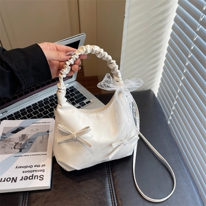 White pleated cloud crescent bag with lace bow handle and slender crossbody strap