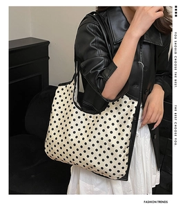 Polka dot tote bag detail showing large capacity and stylish black leather jacket match