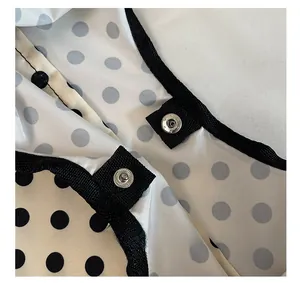 Detail of the magnetic buckle closure on a large capacity polka dot tote bag