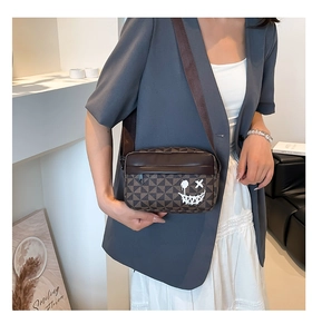 Brown geometric crossbody camera bag with graffiti smile print and wide strap on model