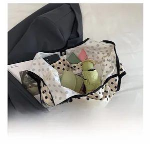 Detail view of polka dot tote bag interior compartments showing large capacity space