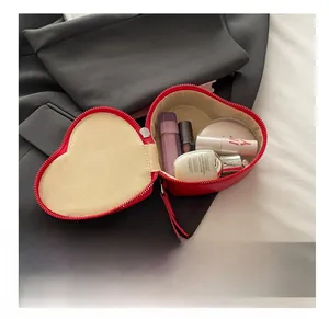 Detailed interior of heart-shaped leather makeup bag showing storage capacity