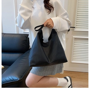 Detail of black woven texture and spacious structure on fashionable tote bag for women