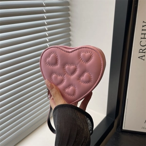 Quilted heart-shaped mini pink clutch bag with silver zipper and black strap