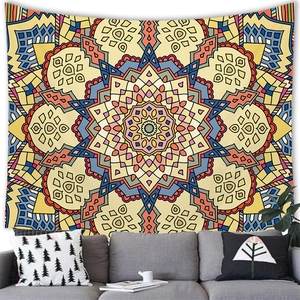 Bohemian mandala wall tapestry with vibrant geometric patterns over a gray living room sofa