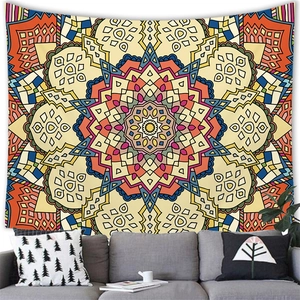Bohemian mandala tapestry with vibrant geometric floral patterns hanging over a sofa