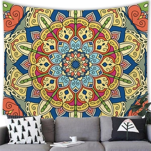 Detailed view of large colorful mandala wall tapestry hanging above a grey sofa decor