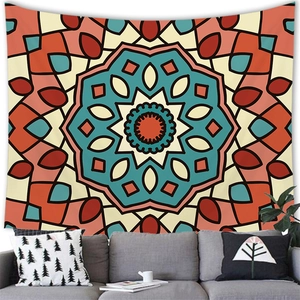 Detail of bohemian mandala tapestry featuring warm orange and teal geometric patterns