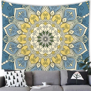 Bohemian mandala tapestry with sunburst pattern hung above a modern living room sofa