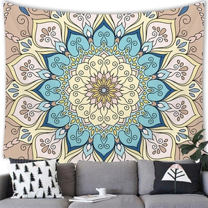 Mandala art tapestry with sunburst patterns above a sofa in a cozy home setting