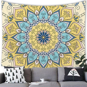 Detail view of the boho mandala tapestry with intricate patterns hanging above a grey sofa