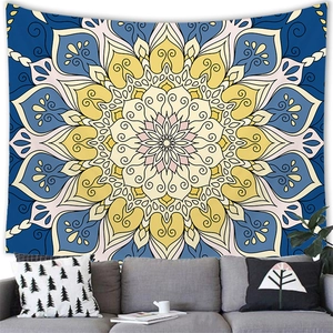 Artistic mandala tapestry with yellow and blue geometry displayed over a modern sofa