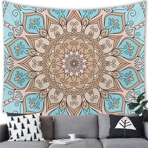 Minimalist blue mandala wall tapestry with geometric floral pattern hanging over sofa