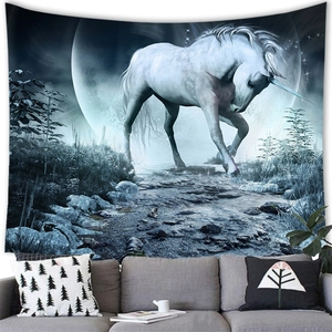Fantasy forest tapestry with white unicorn and full moon above a grey sofa décor