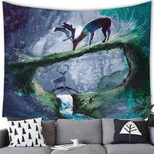 Fantasy forest tapestry with deer and waterfall hanging over a modern gray sofa