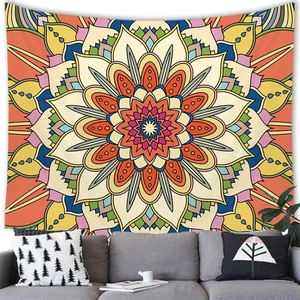 Bohemian mandala tapestry with colorful geometric patterns hanging over a modern sofa