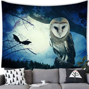 Detail of forest tapestry with barn owl and full moon hanging above a modern sofa