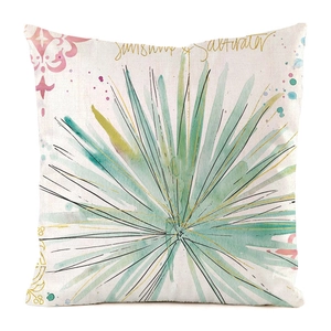 Detail showing the watercolor palm leaf print and sunshiny text on the square cushion cover