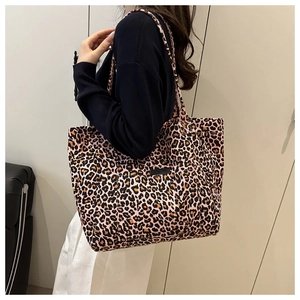 Close-up of pink leopard print canvas tote bag with shoulder straps and front pocket