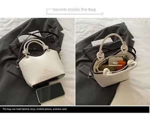 Detail view of white bucket bag interior showing capacity for phone and wallet