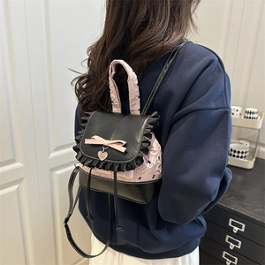 Pink quilted mini backpack for women with black leather flap and heart charm detail