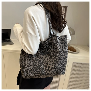Detailed macro view of high-capacity leopard print tote bag with thick canvas texture