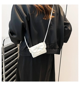 Detailed back view of a white mini bow shoulder bag with elegant lace trim details