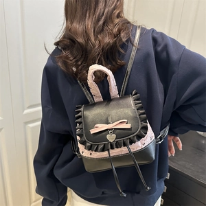 Chic pink and black girls' backpack with lace ruffles, bow detail and heart pendant