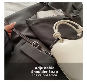 Detail of adjustable shoulder strap and knotted handle on minimalist crossbody bag