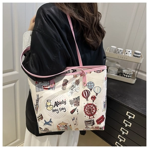 Detail of colorful graffiti print on a white tote bag with pink leather straps