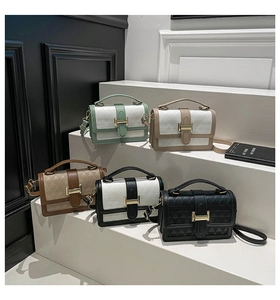 Detailed view of textured crossbody bags with gold H-buckles in five color variations