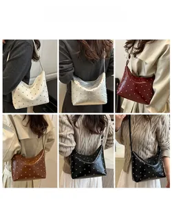 Fashion hobo bag with silver studs shown in five colors on a model for daily wear