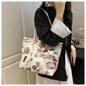 Detail of off-white tote bag with Hong Kong city illustration and slim shoulder strap