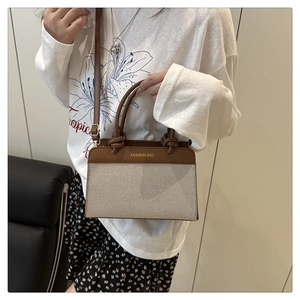 Canvas and leather patchwork handbag with 'FASHION BAG' print and woven handles