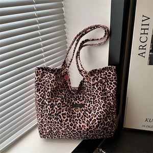 Pink leopard print canvas tote bag with black logo patch and large capacity for daily commute
