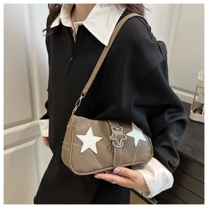 Brown vintage shoulder bag with white star details and star-shaped metal buckle on model