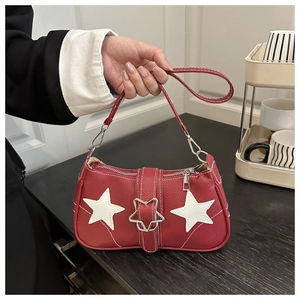 Close-up of red pebbled leather bag featuring white star patches and metal star buckle