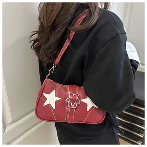 Macro detail of red denim star bag with silver buckle and star pattern accents