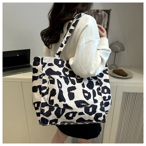 Macro detail of the high-capacity leopard print tote bag with stylish front flap pocket