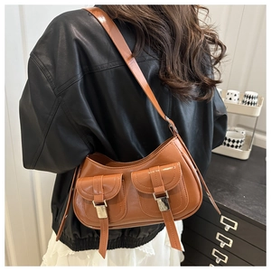 Caramel brown leather shoulder bag with dual front flap pockets and silver buckles