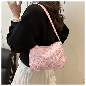 Pink pleated floral underarm bag with bow patterns styled with a casual autumn outfit