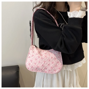Fashionable pink bow print underarm bag shown as a casual shoulder bag outfit detail