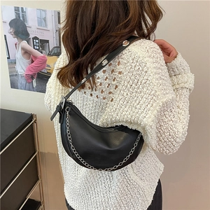 Black PU leather half-moon hobo bag with silver chain and metal eyelet strap detail