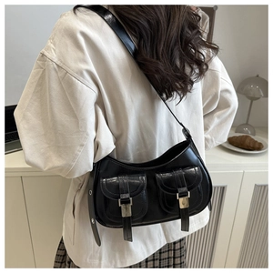 Detail view of vintage black oil-wax leather shoulder bag with pockets and silver hardware