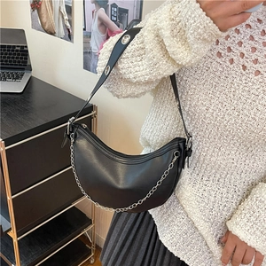 Minimalist black half-moon crossbody bag with silver chain and adjustable strap